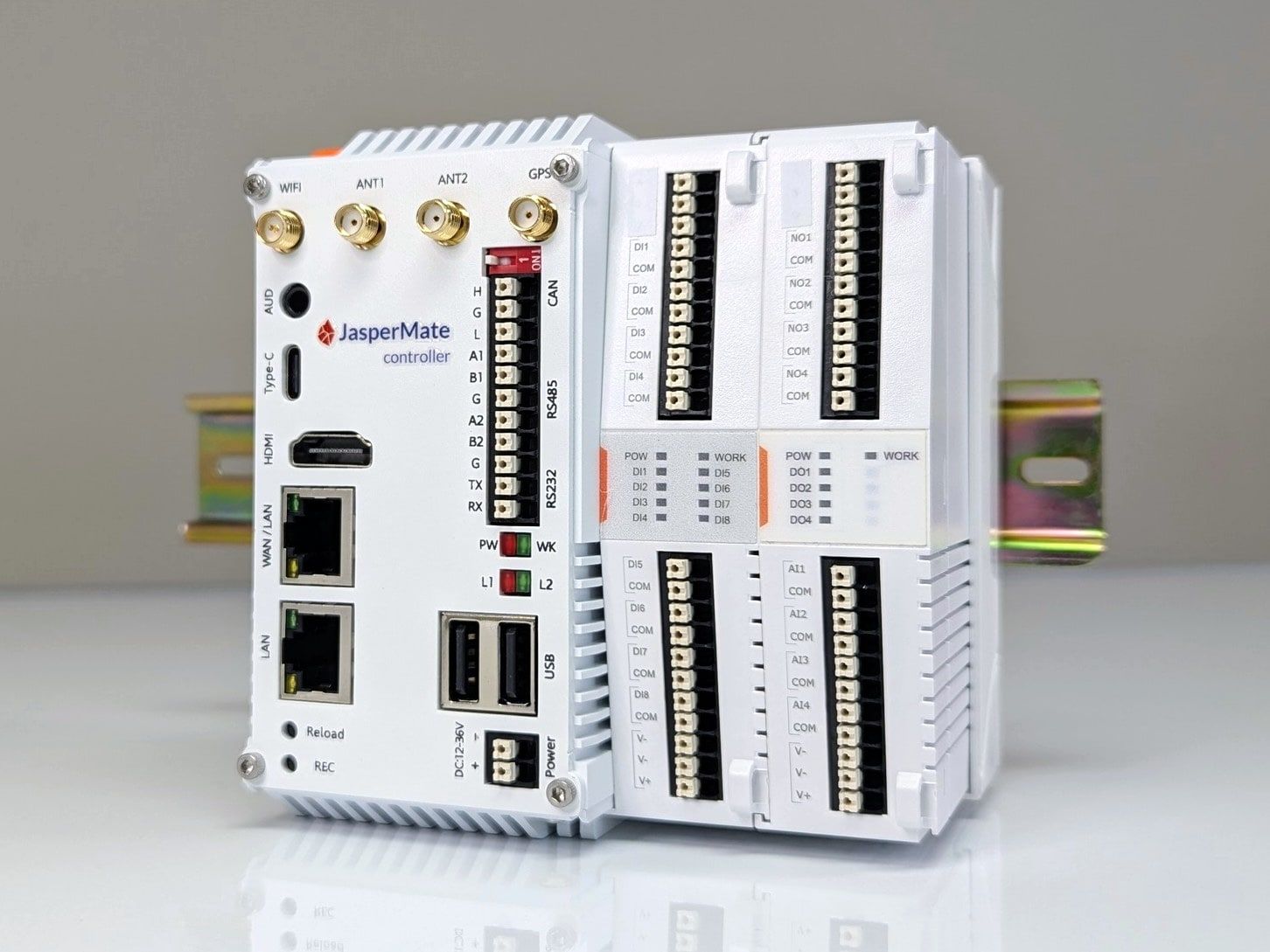 A JasperMate on a DIN rail: the controller, with antenna sockets, two Ethernet ports, USB and serial terminals, beside its onboard I/O for 8 digital inputs, 4 relay outputs and 4 analogue inputs